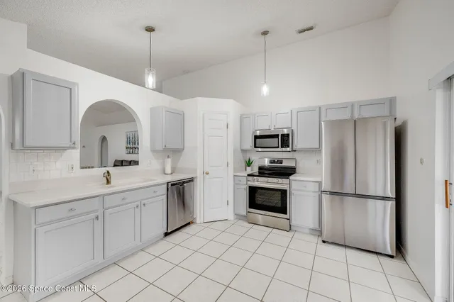 a kitchen with a sink cabinets and appliances