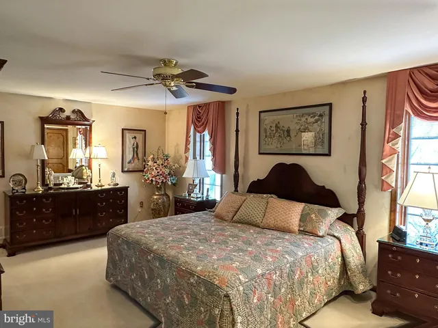 a living room with furniture and floor to ceiling windows