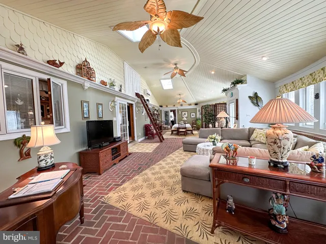 a living room with furniture fireplace and a window