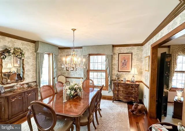 a dining room with furniture a chandelier and window