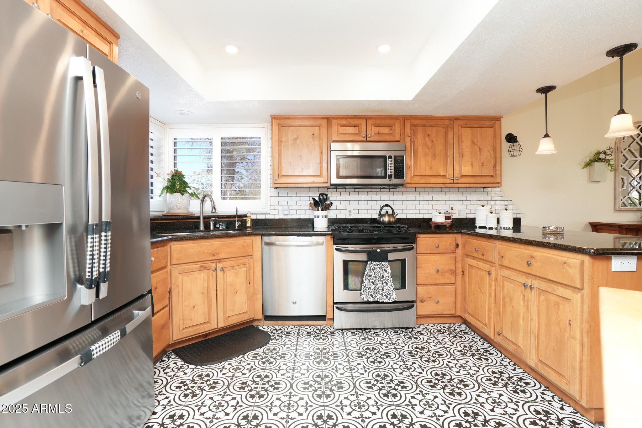 1665 Mountain View Road Cornville, AZ 86325 - Photo 11 of 46 a kitchen with stainless steel appliances granite countertop a stove a sink and a refrigerator