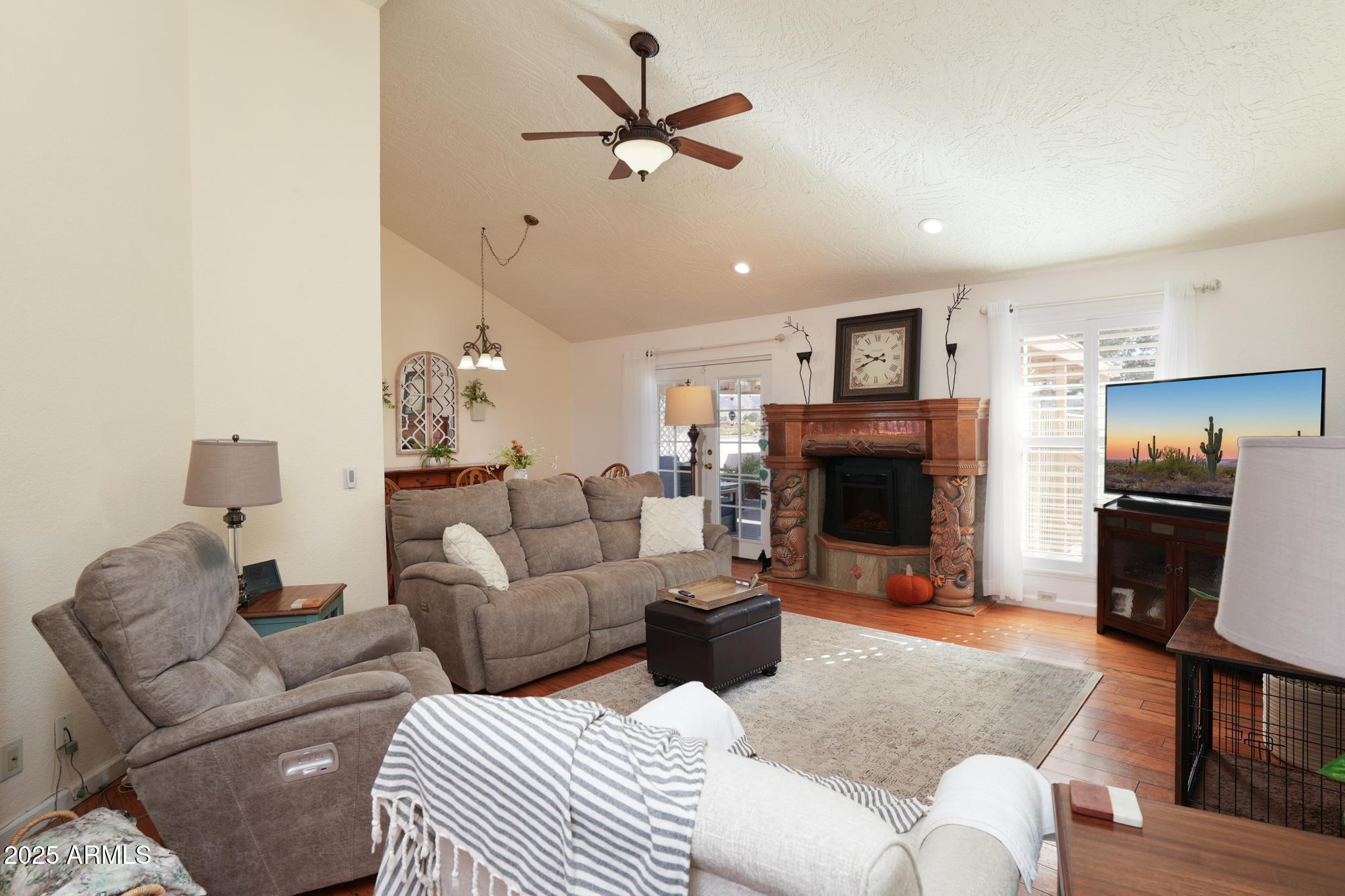 1665 Mountain View Road Cornville, AZ 86325 - Photo 14 of 46 a living room with furniture a fireplace and a ceiling fan