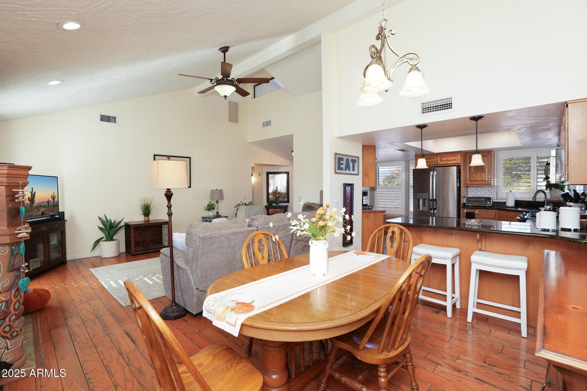 1665 Mountain View Road Cornville, AZ 86325 - Photo 15 of 46 a view of a dining room with furniture and wooden floor