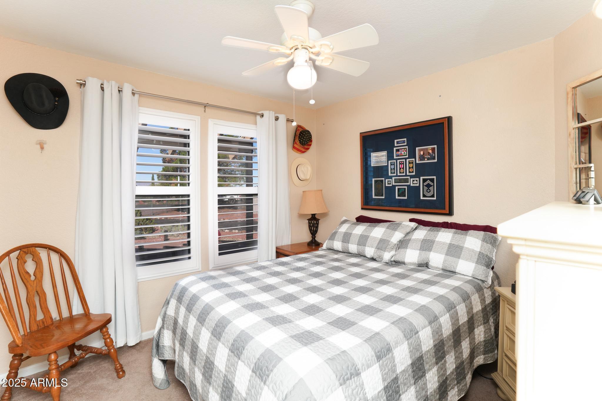 1665 Mountain View Road Cornville, AZ 86325 - Photo 16 of 46 a bedroom with a bed and a chandelier