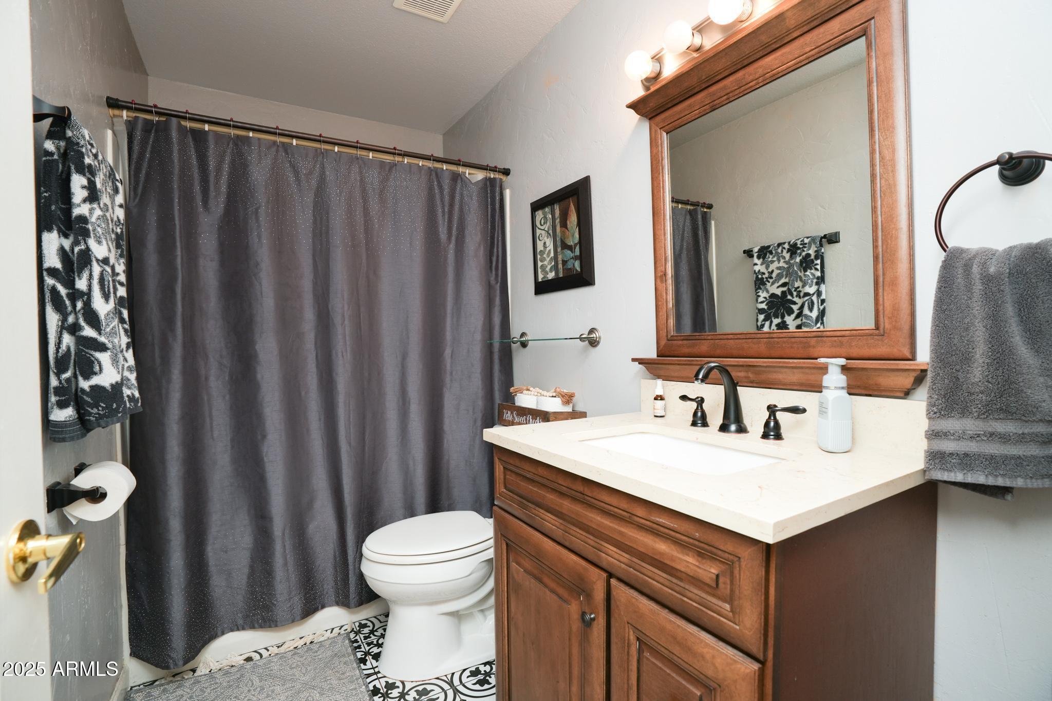 1665 Mountain View Road Cornville, AZ 86325 - Photo 25 of 46 a bathroom with a sink vanity mirror and toilet