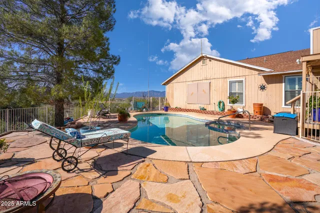 a view of a house with backyard and sitting area
