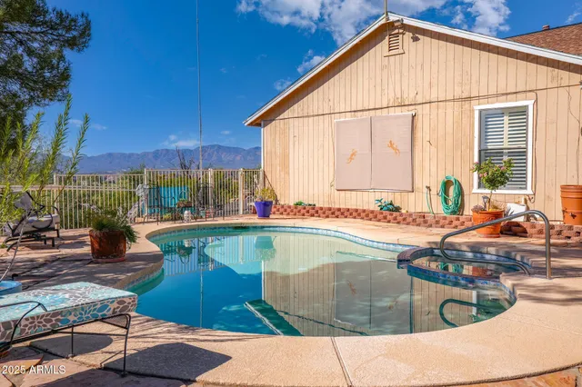 a swimming pool with outdoor seating and yard