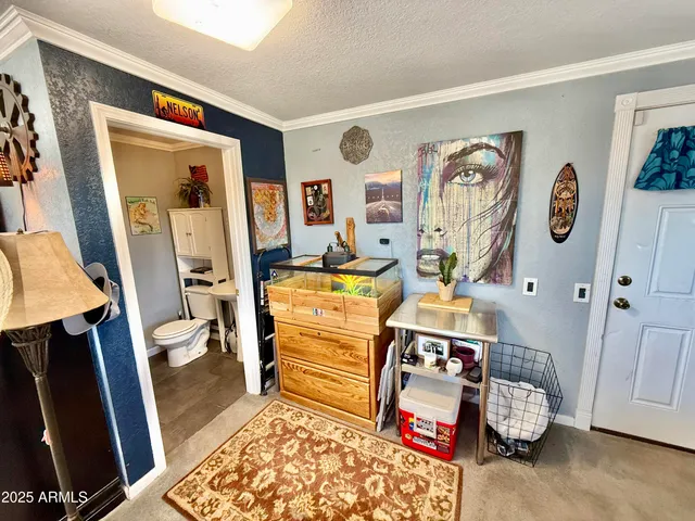 a bed room with a bed a desk and mirror