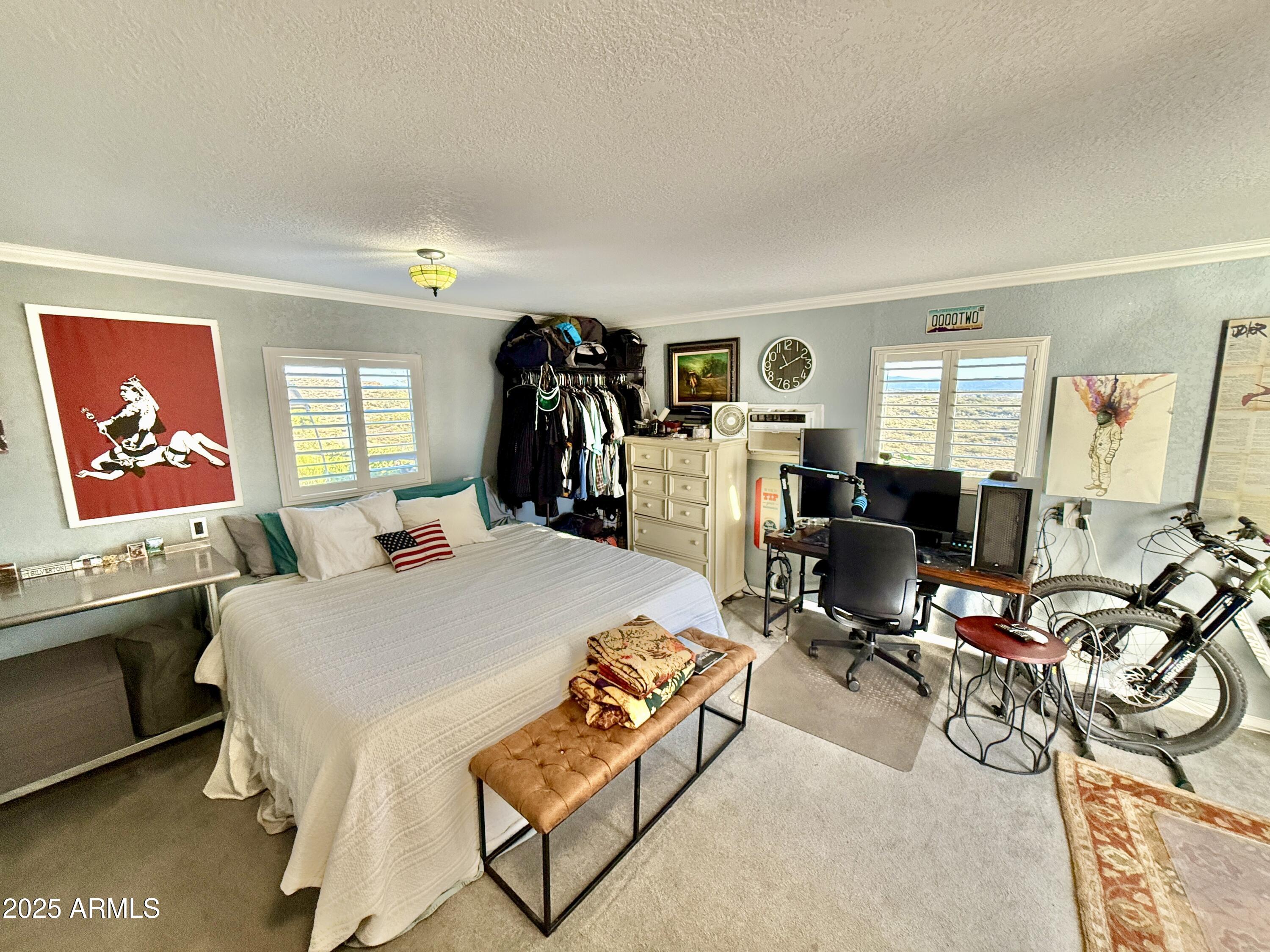 1665 Mountain View Road Cornville, AZ 86325 - Photo 42 of 46 a bed room with a bed a desk and mirror