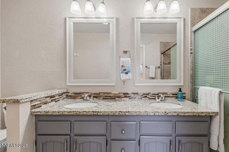 675 College Drive Reno, NV 89503 - Photo 19 of 30 a bathroom with a granite countertop sink and a mirror