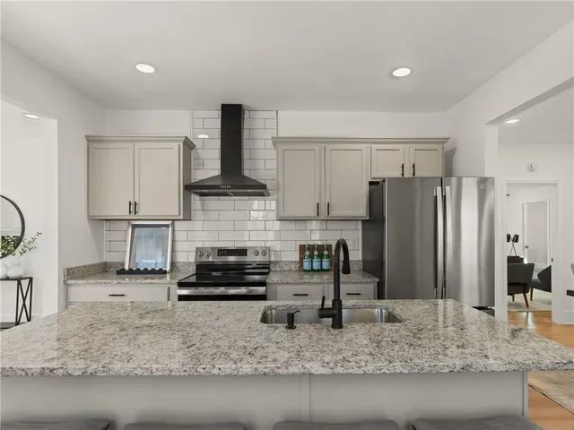a large kitchen with lots of counter space and stainless steel appliances