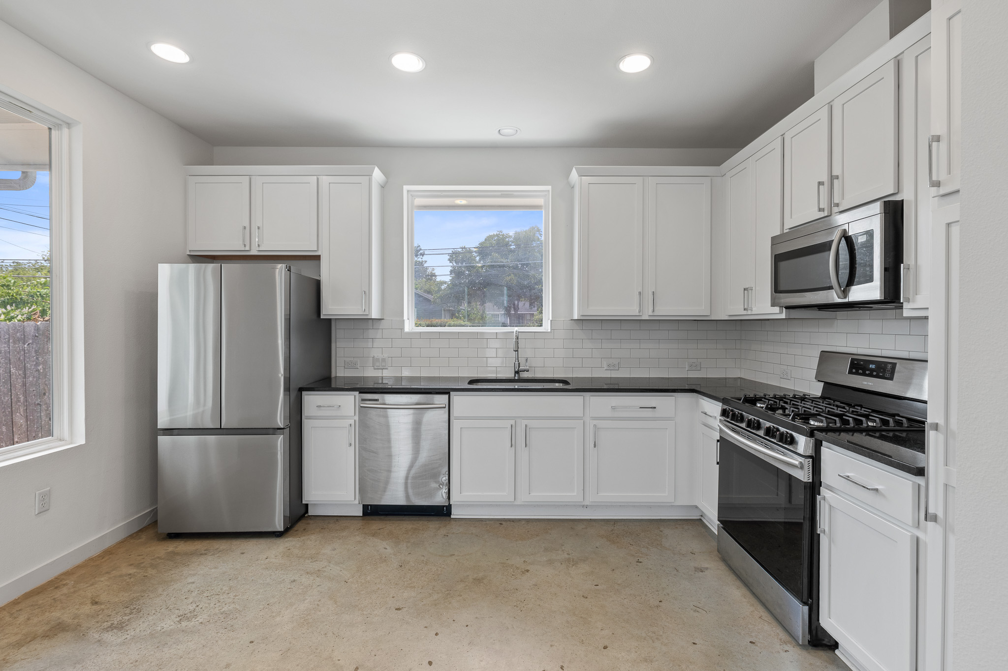 2604 Wheless Lane, Unit 1 Austin, TX 78723 - Photo 11 of 38 Stainless steel appliances—including gas range and dishwasher—offer quality finishes and modern functionality.
