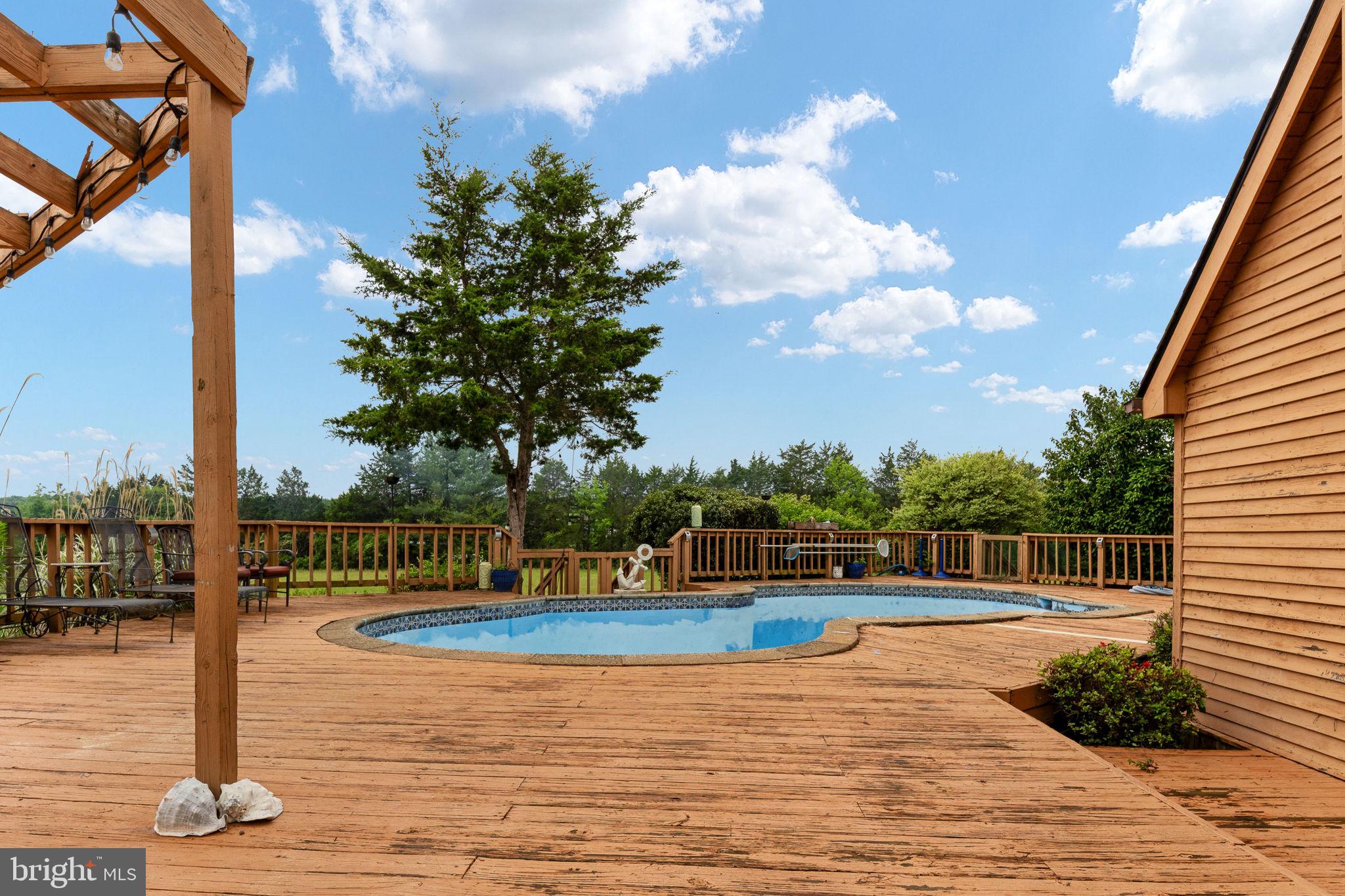 6119 Beach Road Midland, VA 22728 - Photo 66 of 98 a view of swimming pool with seating space and wooden fence