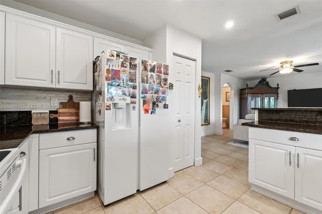 a view of a patio with a table and chairs and potted plants