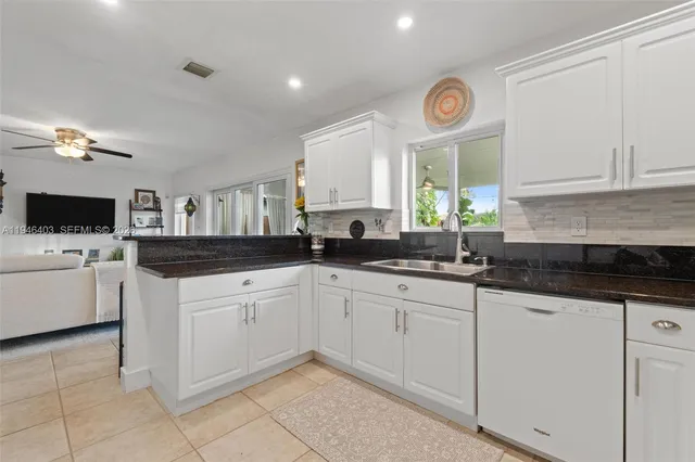 a view of a house with a yard and sitting area