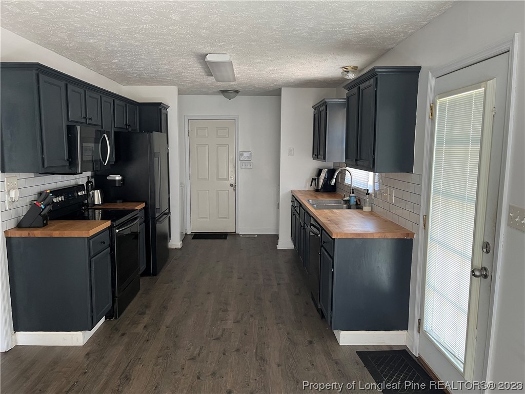 11 Overlook Road Cameron, NC 28326 - Photo 3 of 12 a kitchen with stainless steel appliances granite countertop a refrigerator stove and sink