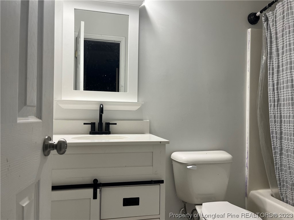 11 Overlook Road Cameron, NC 28326 - Photo 6 of 12 a bathroom with a sink toilet and mirror