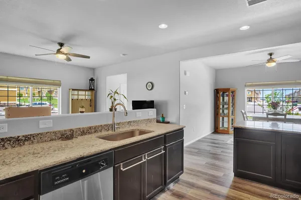 a spacious bathroom with a granite countertop sink a large mirror and shower