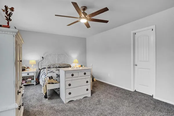 a bathroom with a granite countertop sink toilet a large mirror and shower curtain