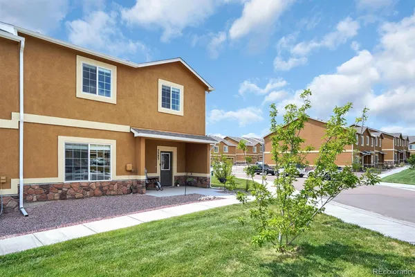 a front view of house and yard with green space