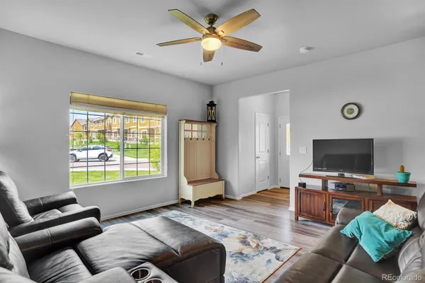 a bedroom with furniture and a flat screen tv