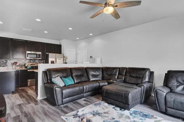 a living room with furniture and kitchen view