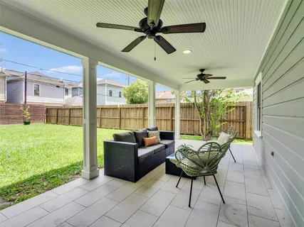 a living room with patio furniture and a floor to ceiling window