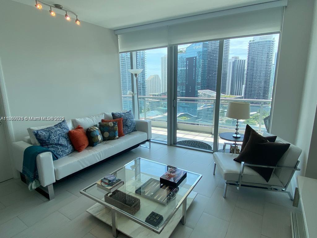 92 Southwest 3rd Street, Unit 3102 Miami, FL 33130 - Photo 2 of 15 a living room with furniture and a floor to ceiling window