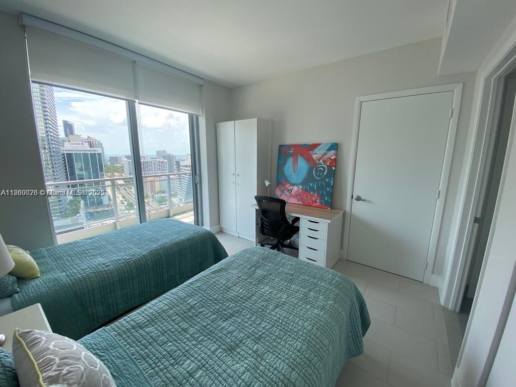 92 Southwest 3rd Street, Unit 3102 Miami, FL 33130 - Photo 8 of 15 a bedroom with a bed and a window