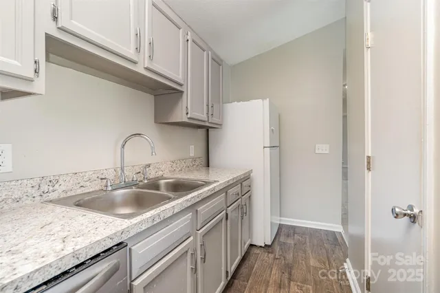 a kitchen with a sink and refrigerator