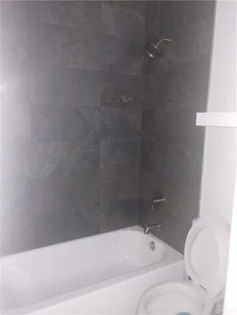 a bathroom with a bathtub and a toilet