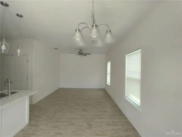a view of a room with wooden floor and windows