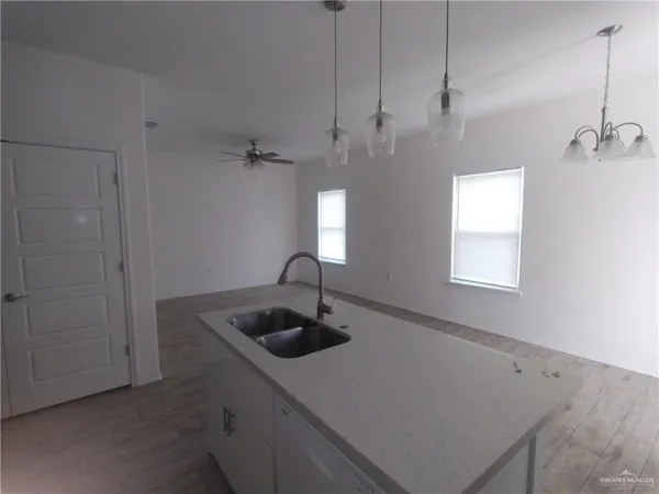 a kitchen with a sink a counter space and a window