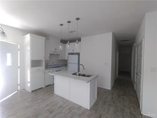 a kitchen that has a lot of cabinets in it