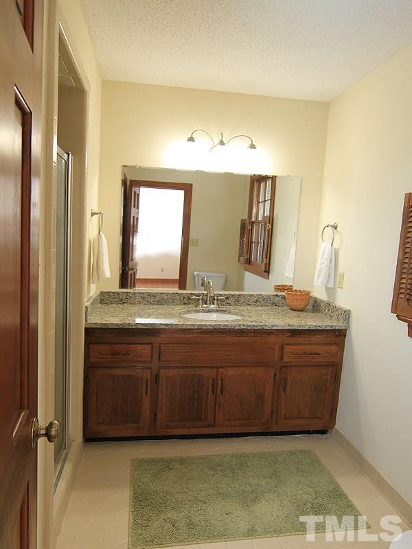 8013 Old Deer Trail Raleigh, NC 27615 - Photo 14 of 23 New granite and raised counter top. Full size walk in shower!