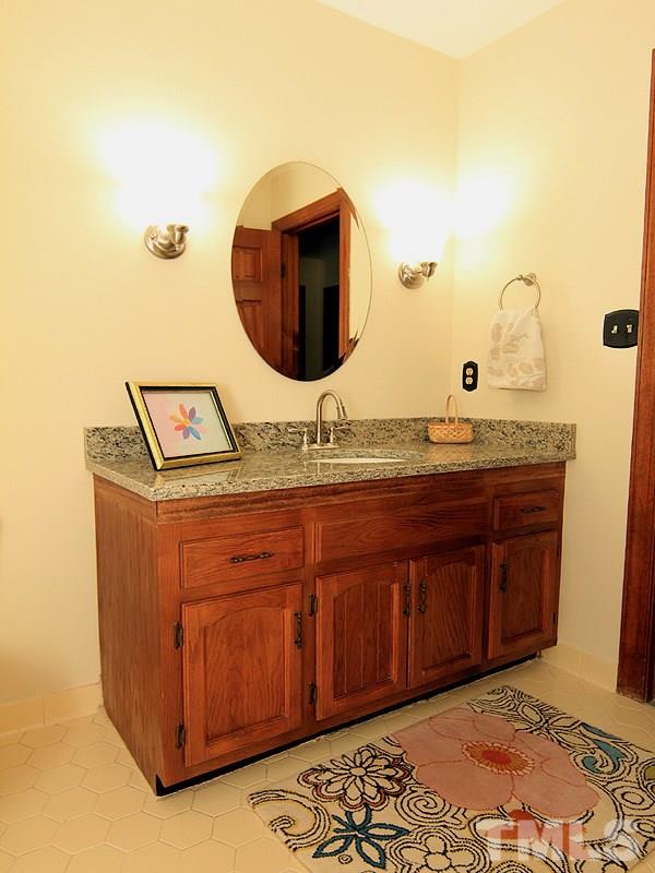 8013 Old Deer Trail Raleigh, NC 27615 - Photo 15 of 23 New Granite, lighting, sink and mirror!