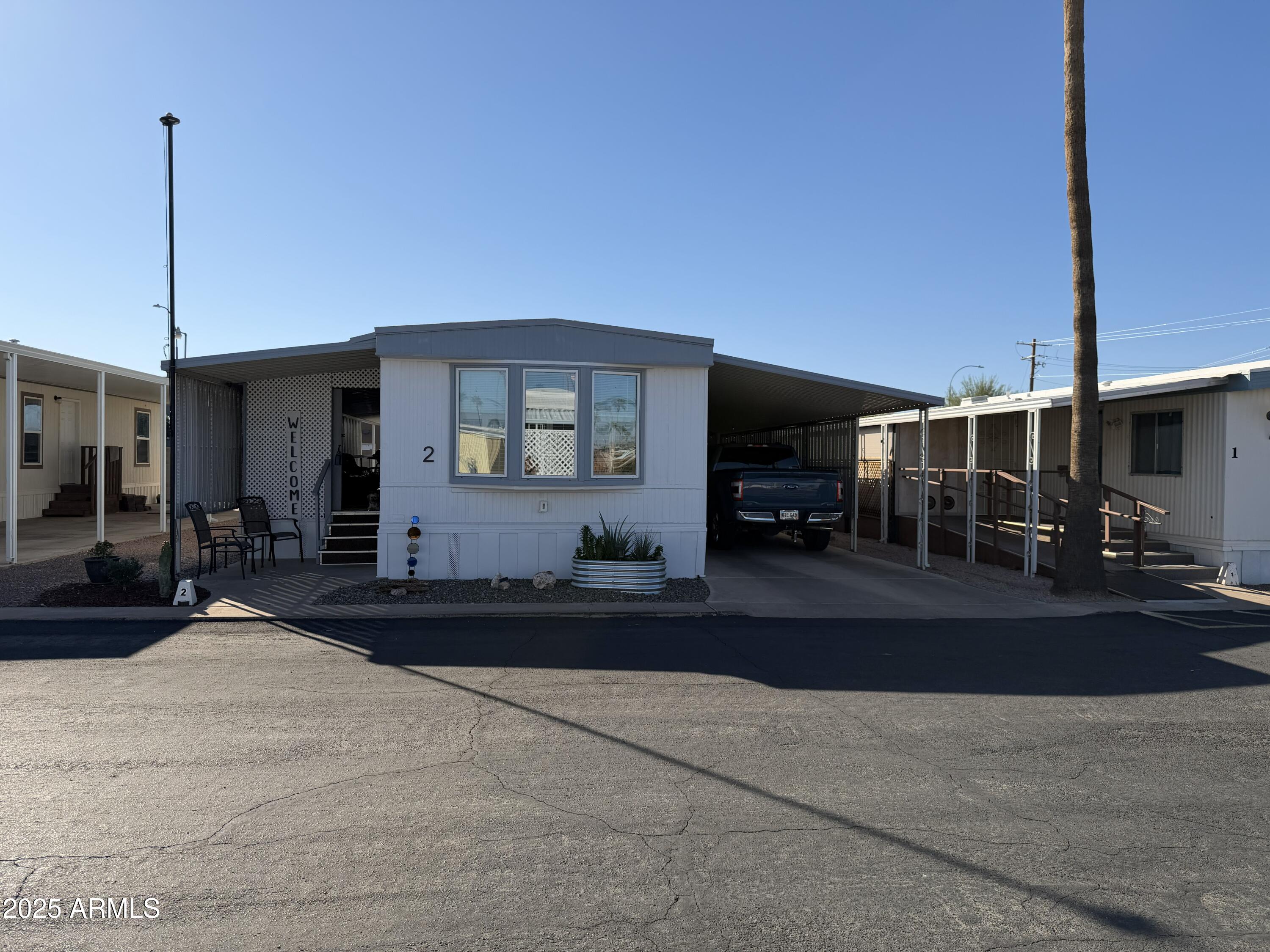 351 North Meridian Drive, Unit 2 Apache Junction, AZ 85120 - Photo 1 of 26 a front view of a house with a yard