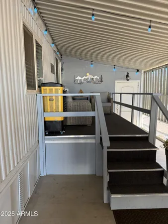 a living room with furniture a flat screen tv and dresser