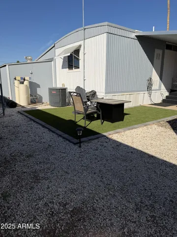 a backyard of a house with table and chairs