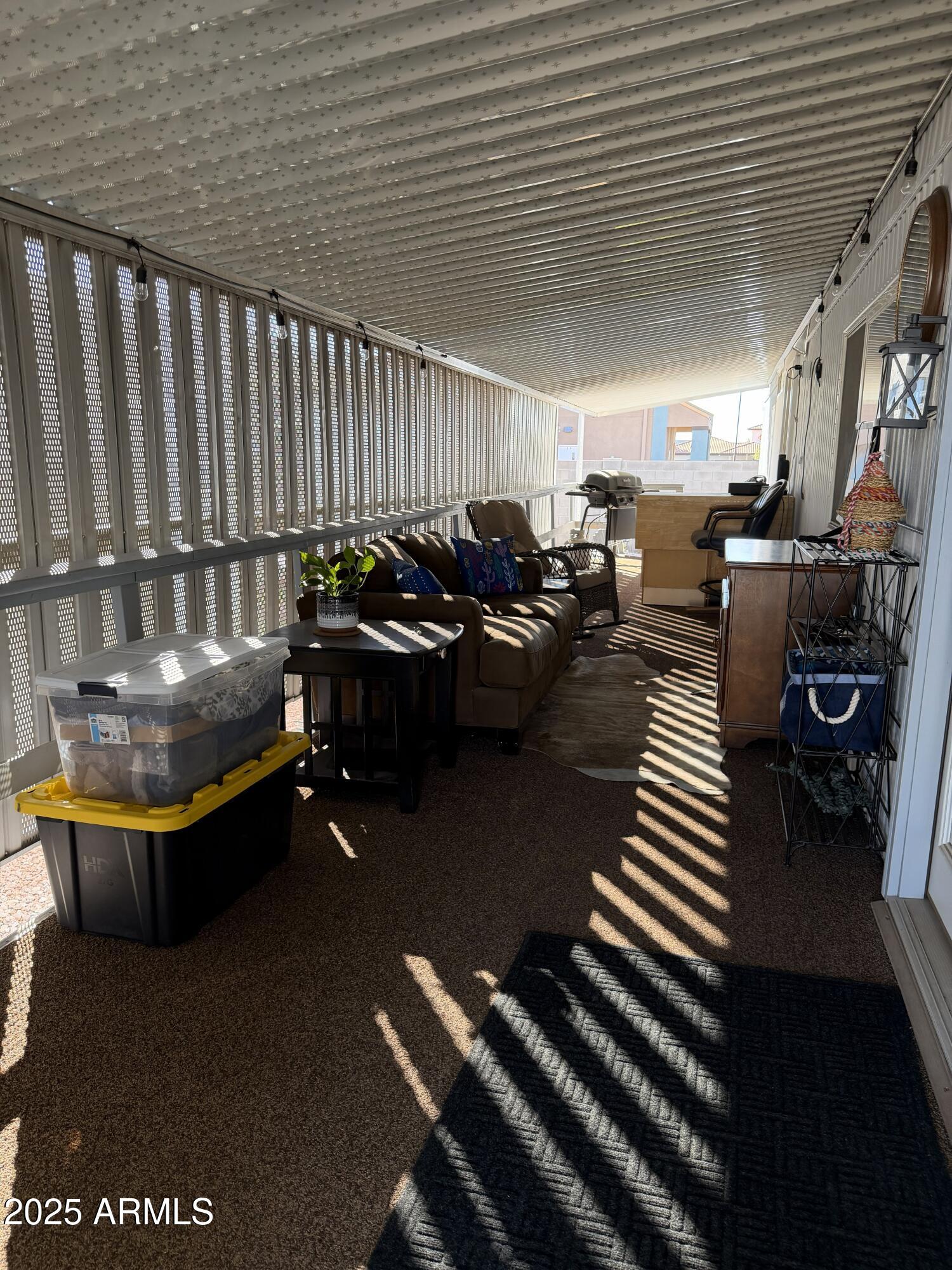 351 North Meridian Drive, Unit 2 Apache Junction, AZ 85120 - Photo 24 of 26 a living room with patio furniture and a wooden floor