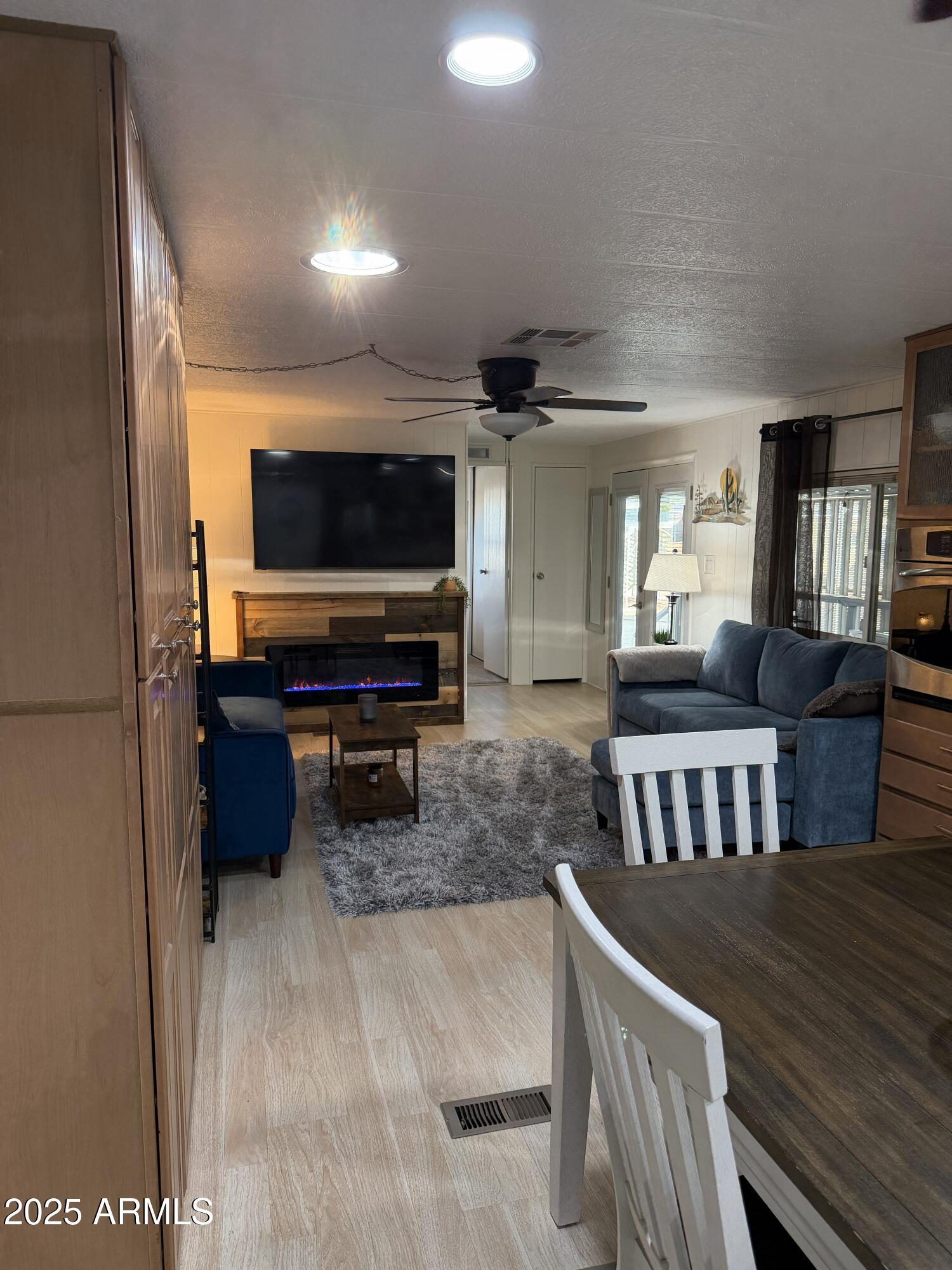 351 North Meridian Drive, Unit 2 Apache Junction, AZ 85120 - Photo 5 of 26 a living room with furniture and a flat screen tv