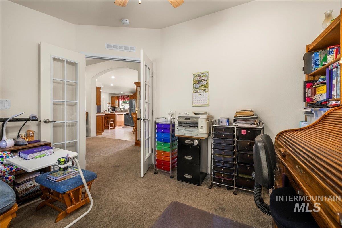37786 Highway 78 Grand View, ID 83624 - Photo 12 of 50 Office area with carpet, french doors, arched walkways, vaulted ceiling, and ceiling fan