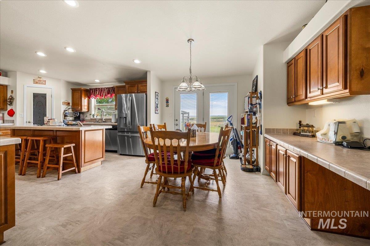 37786 Highway 78 Grand View, ID 83624 - Photo 13 of 50 Dining space featuring light flooring, recessed lighting, and a chandelier