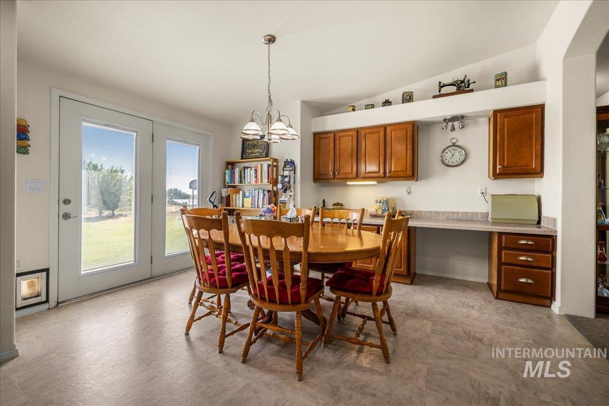 37786 Highway 78 Grand View, ID 83624 - Photo 14 of 50 Dining room featuring lofted ceiling, light flooring, and a chandelier