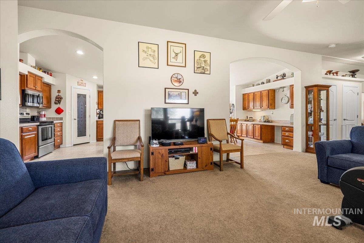 37786 Highway 78 Grand View, ID 83624 - Photo 19 of 50 Living room featuring arched walkways, recessed lighting, a ceiling fan, and light colored carpet