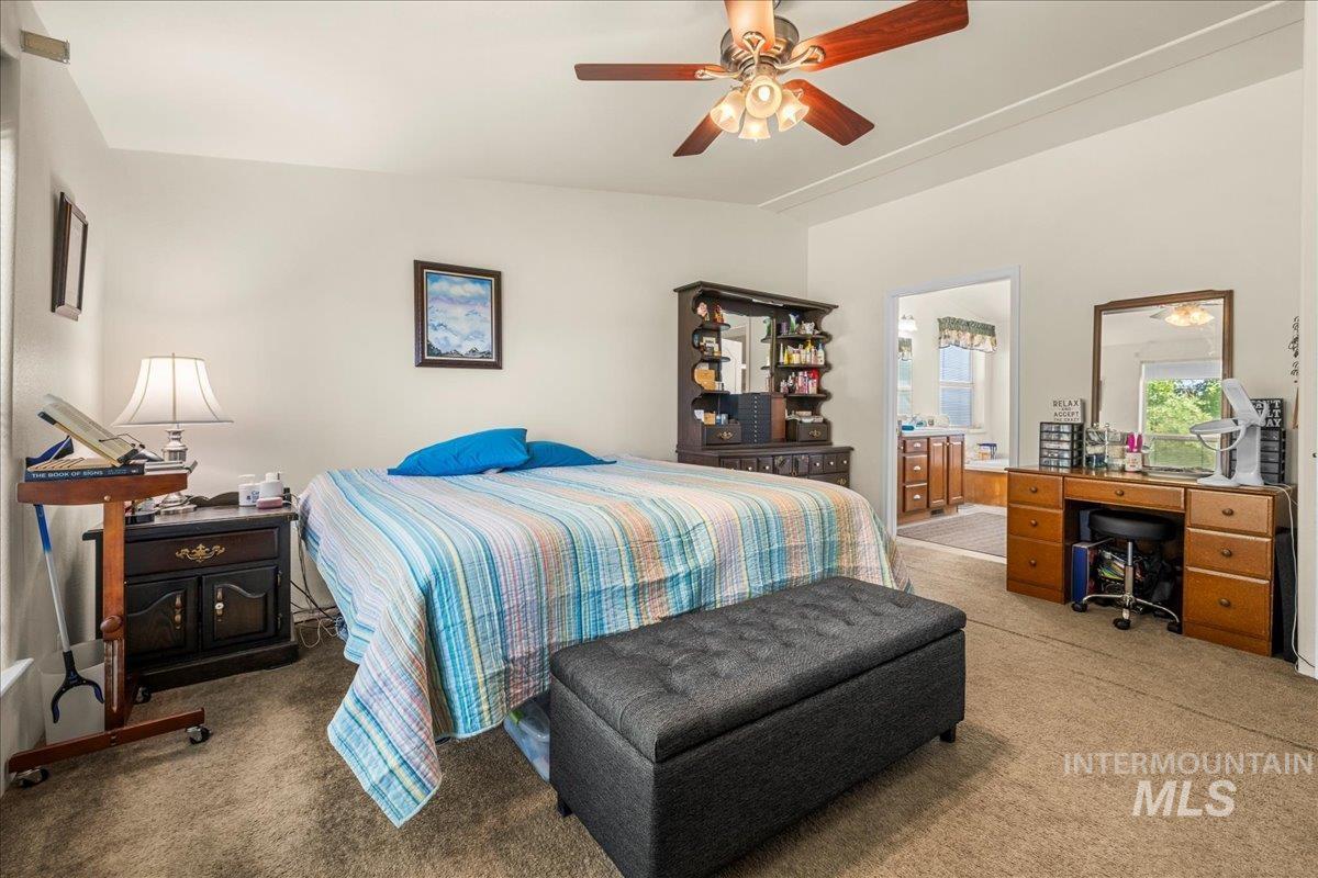 37786 Highway 78 Grand View, ID 83624 - Photo 35 of 50 Bedroom with carpet flooring, an office area, a ceiling fan, and ensuite bath