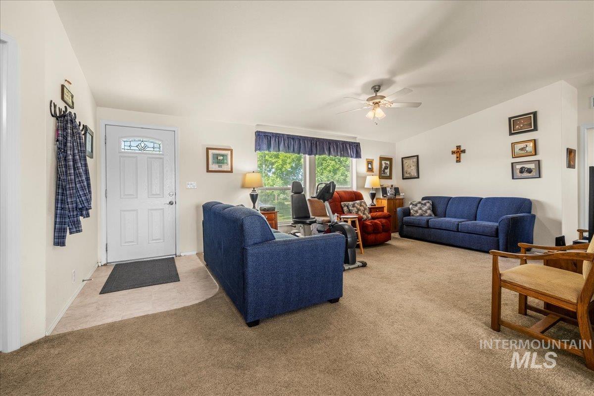 37786 Highway 78 Grand View, ID 83624 - Photo 6 of 50 Living room with light carpet and a ceiling fan