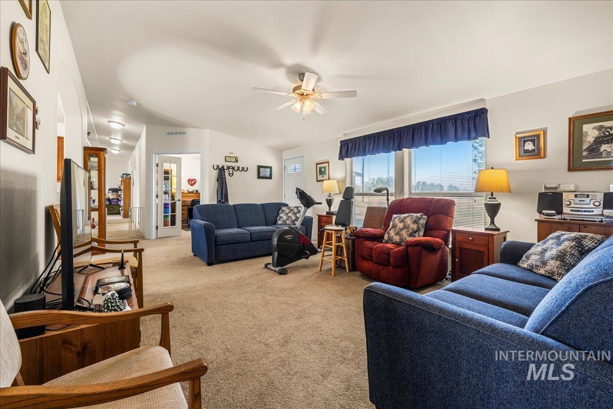 37786 Highway 78 Grand View, ID 83624 - Photo 9 of 50 Living room featuring light carpet, a ceiling fan, and lofted ceiling