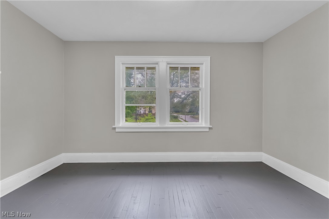 1144 East 145th Street, Unit 1/RIGHT Cleveland, OH 44110 - Photo 15 of 20 Neutral gray wall finish, dark wood-finish flooring, white baseboards, and a double window with white trim