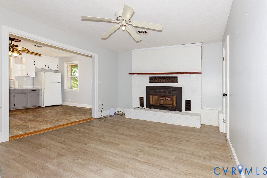 9903 Boze Road Ford, VA 23850 - Photo 15 of 45 a view of an empty room with a fireplace and a window